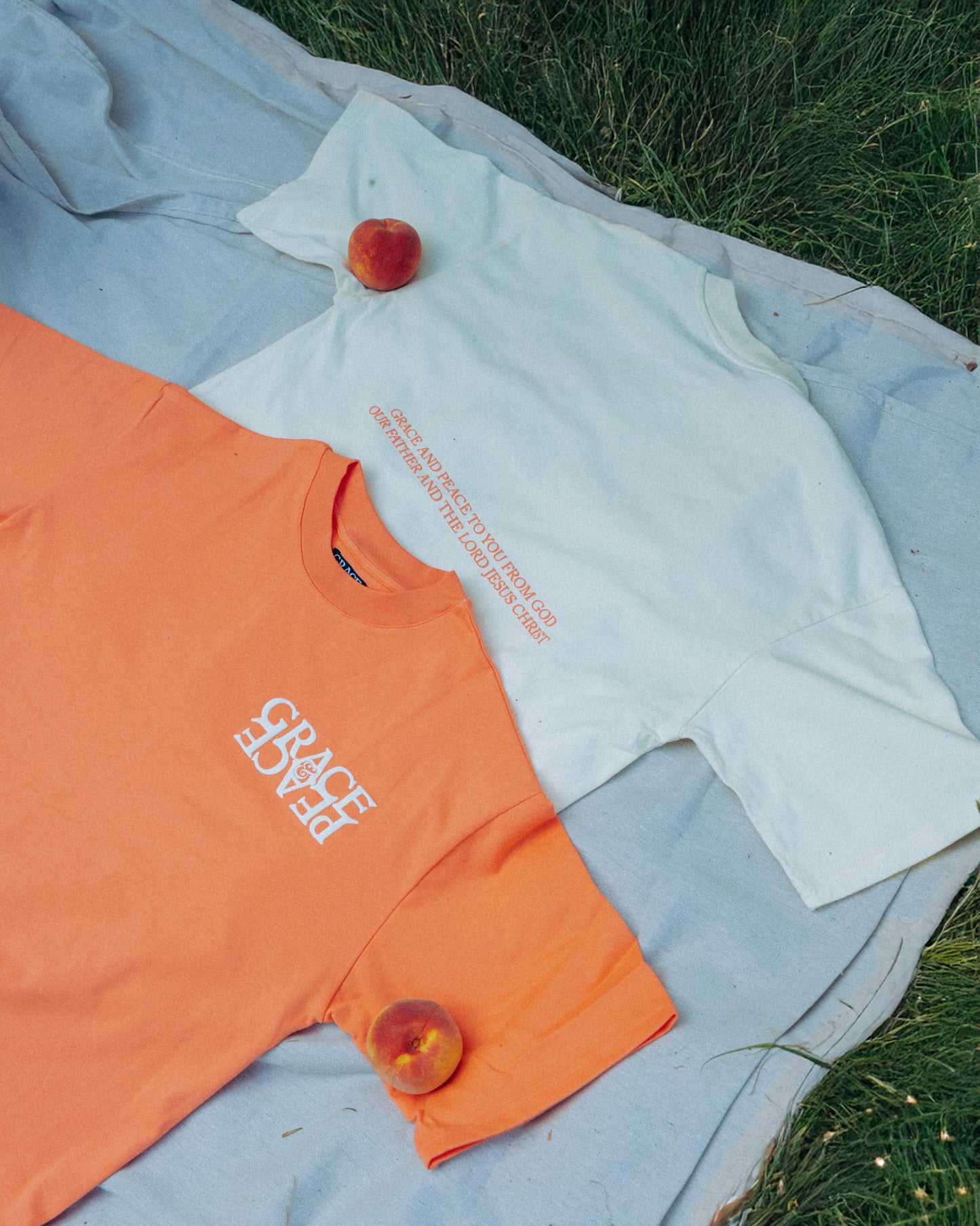 Peach and Cream tshirt with peach text on a pinic blanket 