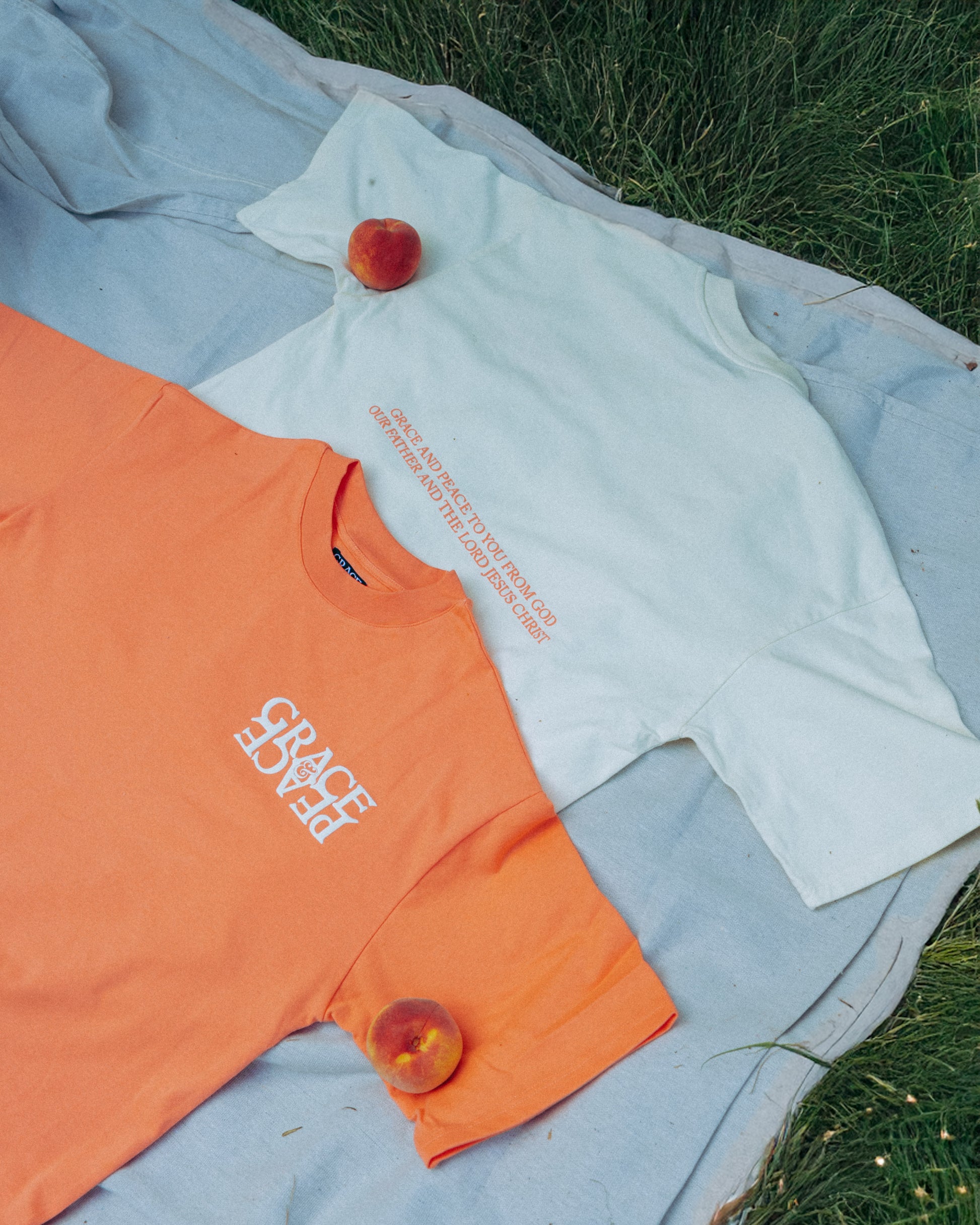 Peach and Cream tshirt with peach text on a pinic blanket 